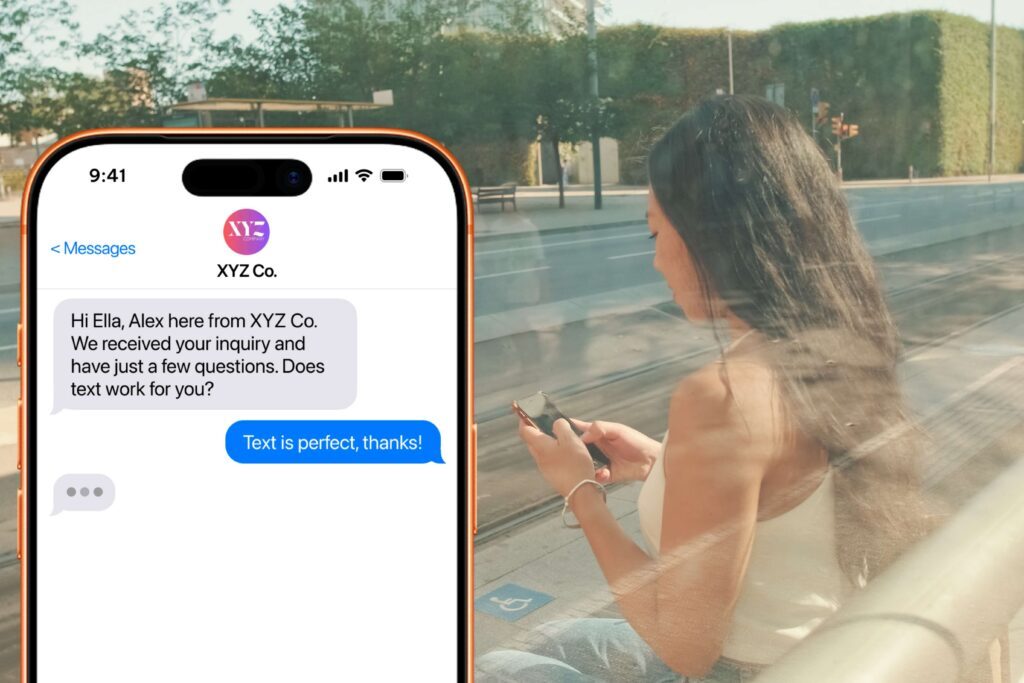 Woman texting at a bus stop